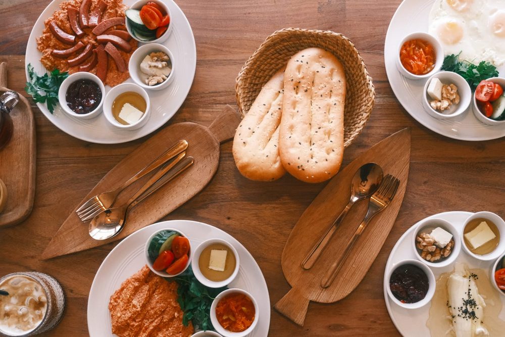 Kaymak and honey platter with cheese, bread, and jam